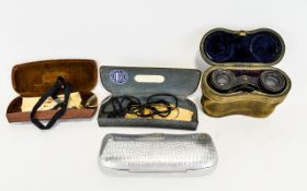 A Pair Of Antique Opera Glasses Housed in original leather case, an unusual example in heavyweight