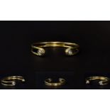 A Solid 9ct Yellow Gold Diamond Set Bangle From The 1960's / 1970's. The Bangle Ends Each Pave Set