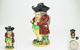 Staffordshire Early 19thC 'Snuff Taker' Toby Jug, the gentleman wearing a maroon coat, green