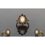 Ladies 9ct Gold Opal And Garnet Cluster Ring The central opal surrounded by 14 garnet in a