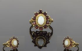 Ladies 9ct Gold Opal And Garnet Cluster Ring The central opal surrounded by 14 garnet in a