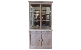 Contemporary Display Cabinet Corner cabinet in pale grey/peach tone wood with two glass front doors,