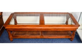 Coffee Table Large low rectangular coffee table in dark wood with bevelled glass top and woven