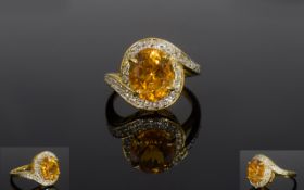 Citrine and White Topaz Ring, an oval cut citrine of 3.5cts and rich dark golden hue, framed by