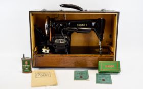 Singer 201K Sewing Machine with various accessories.