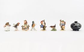A Small Collection Of Ceramic Figures Eight in total to include three small Hummel figures,