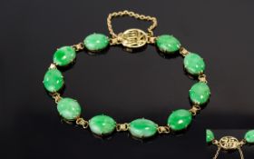 Jade Tennis Bracelet, oval cabochons of mottled green jade set in 14ct gold,