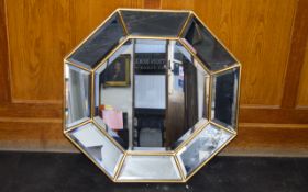 A Contemporary Octagonal Mirror Bevelled glass mirror in burnished gilt frame with central octagon