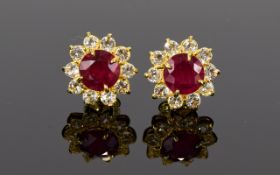 Ruby and White Topaz Halo Stud Earrings, each earring comprising a 2ct round cut, rich red ruby,