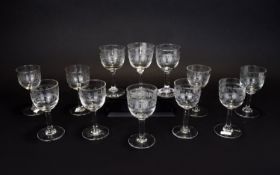 A Set Of Whisky Glasses Twelve in total with etched Greek key borders. Good condition.