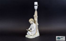 Lladro Lamp Base A charming lamp base in the form of a young girl in nightdress reading a book