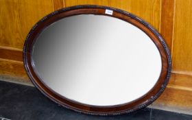 Antique Oval Over Mantle Mirror Bevelled glass mirror with deep mahogany frame and subtle beading
