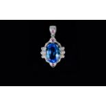 A 9ct White Gold Blue Topaz and Diamond Set Pendant Drop.