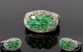 Emerald Cluster Ring, ten small oval cut emeralds set in a silver millgrain frame, and plain shank,