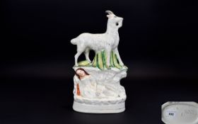 Staffordshire Pottery 19th Century Figure Group - The Figure of a Large Coat Above a Sleeping Child.