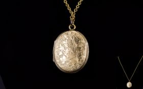 Antique Period 9ct Gold Oval Shaped Hinged Locket with Chased Decoration,