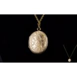 Antique Period 9ct Gold Oval Shaped Hinged Locket with Chased Decoration,