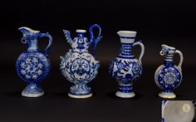 Four Various Small Westerwald Ewers, one with grape and vine decoration and bird mask spout, 7.