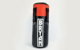 Boxing Training Punch Bag A small black and red cylindrical punch bag by Bryan.