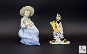 A Nao Figure In The Form Of A Young Girl With Infant Seated figure of a girl in straw hat,