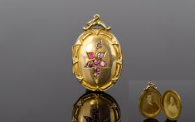 Antique 9ct Gold Back and Front Oval Shaped Ornate Hinged Locket, Set with Rubies to Front Panels.