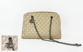 Channel Style Taupe Pearlised Finish Quilted Leather Handbag with Chain Handles and Channel Motif.