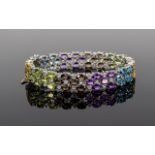 Multi Gemstone Three Row Bracelet, set with sections of oval cut gemstones comprising Swiss Blue