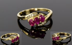 9ct Gold, Diamond and Ruby Cluster Ring, 3 Ruby's set on a twist between 8 channel set diamonds.
