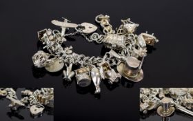 A Good Quality Silver Charm Bracelet Loaded with 18 Good Charms.