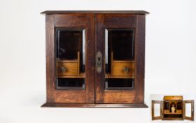 Oak smokers cabinet, double doors with bevelled glass, the interior with 4 drawers,