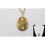 9ct Yellow Gold Large and Impressive Oval Shaped Hinged Locket with Chased Stylish Decoration to