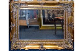 Large Bevelled Glass Mirror in ornate Rococo pale gilt frame. Style reference 'Romany'.