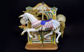 A Reproduction Musical Ceramic Carousel Horse Figure Ceramic figure against wooden box,