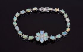 Opal Flower Centred Line Bracelet, the bracelet set with oval cut cabochon opals and the flower with