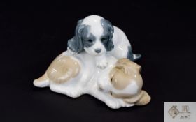 Nao by Lladro Animal Figure Group ' 2 Pups ' Resting. Size 4 x 5.5 Inches.