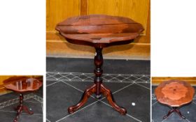 A Decorative Occasional Table, raised on a turned base with trefoil legs.