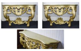 A Pair Of Ornate Console Tables Two reproduction Rococo hall/console tables with intricate apron