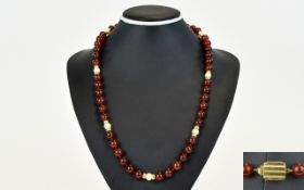 A Contemporary Nice Quality Natural Amber Bead Necklace with Pearl and 9ct Gold Spacers,