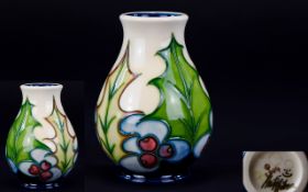 Moorcroft Modern Small Tubelined Vase 'Holly' pattern and berries, date, 2004.