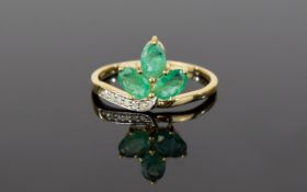Diamond And Emerald Cluster Ring Ladies dress ring with unusual trefoil stone setting and diamond