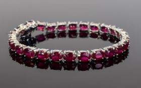 Ruby Tennis Bracelet, 28cts of oval cut, rich red rubies, set over 26 stones,