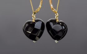 9ct Drop Earrings Wired for pierced ears comprised of 9ct gold fixings with faceted black heart