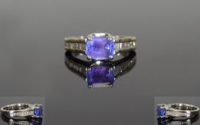 18ct White Gold Single Stone Tanzanite and Baguette Cut Diamond Ring. The Emerald Cut Tanzanite