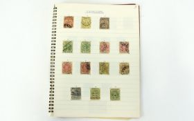 Century notebook with several early British commonwealth stamps.
