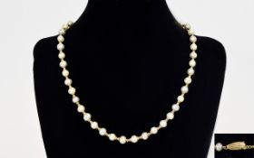 A Good Quality Single Strand Pearl Cultured Necklace with 14ct Gold Spacers and Clasp. Marked 14kt.