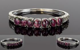 Russian Eudialyte Bangle, a row of seven oval cut cabochons of the natural Russian stone, eudialyte,