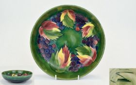 William Moorcroft Signed Large Tubelined Footed Bowl, leaves and berries design on green and blue