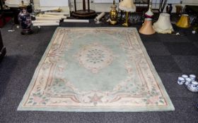 A Large Oriental Style Wool Blend Rug Rectangular rug with central floral cartouche and cream and