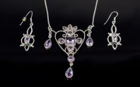 A Silver And Amethyst Set Art Nouveau Style Pendant And Earrings A delicate and intricate pendant