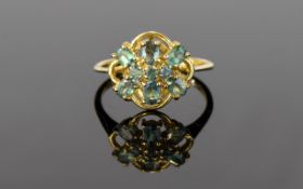 9ct Gem Set Ring Attractive exaggerated flowerhead setting finished with nine pale celadon tone